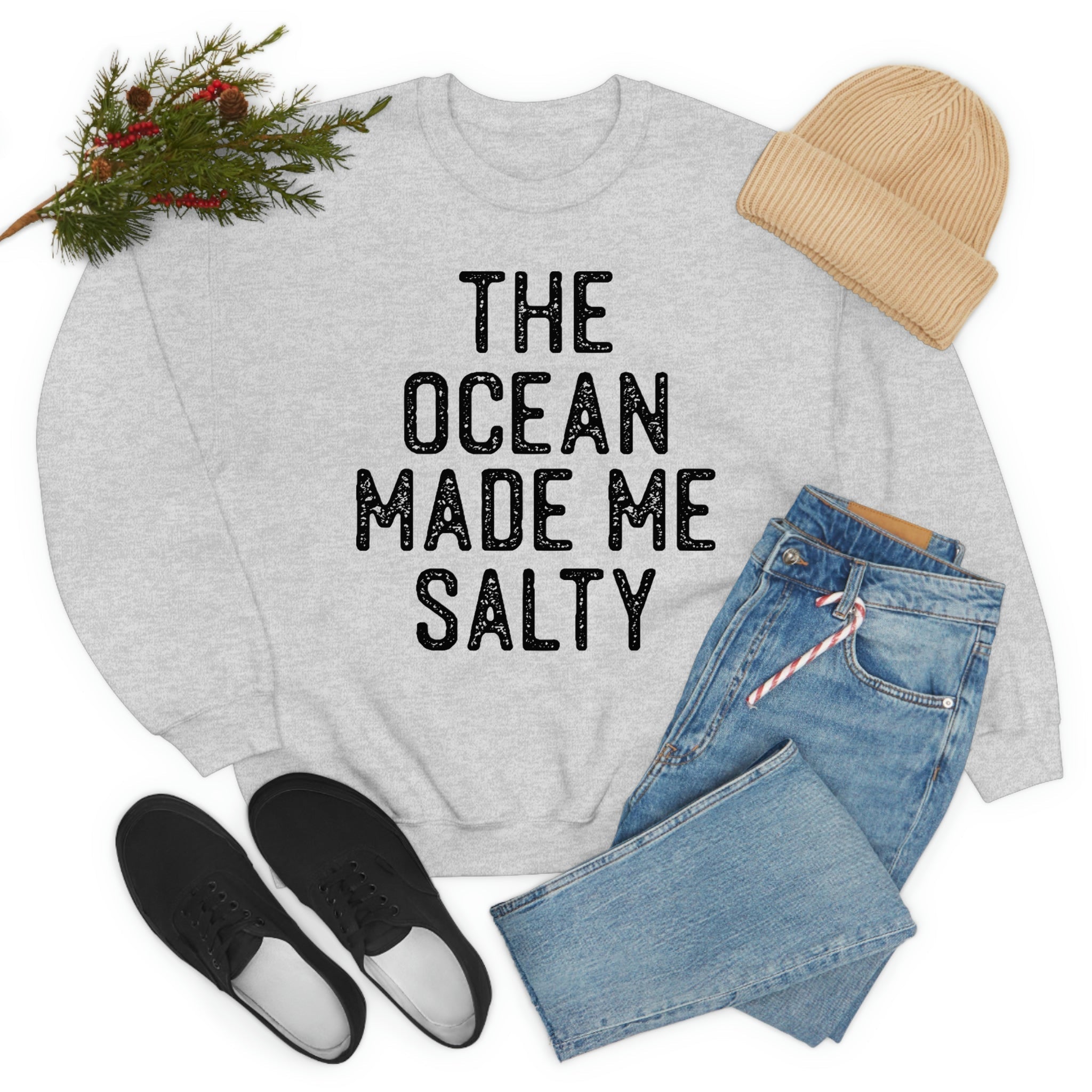 The Ocean Made Me Salty sweatshirt styled with denim jeans, shoes, and a knit hat, perfect for casual fashion.
