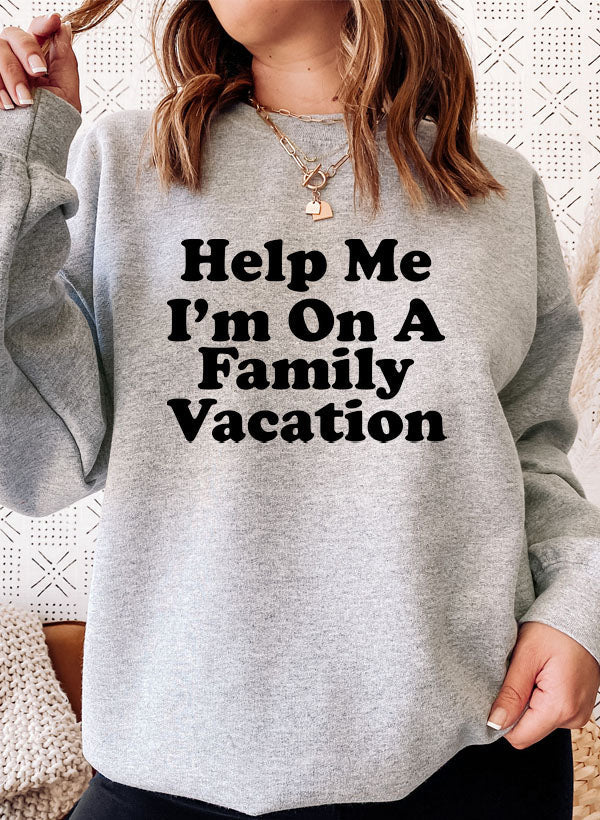 Help Me Im On A Sweat Shirt worn by a woman, featuring bold lettering and a cozy design for stylish outings.