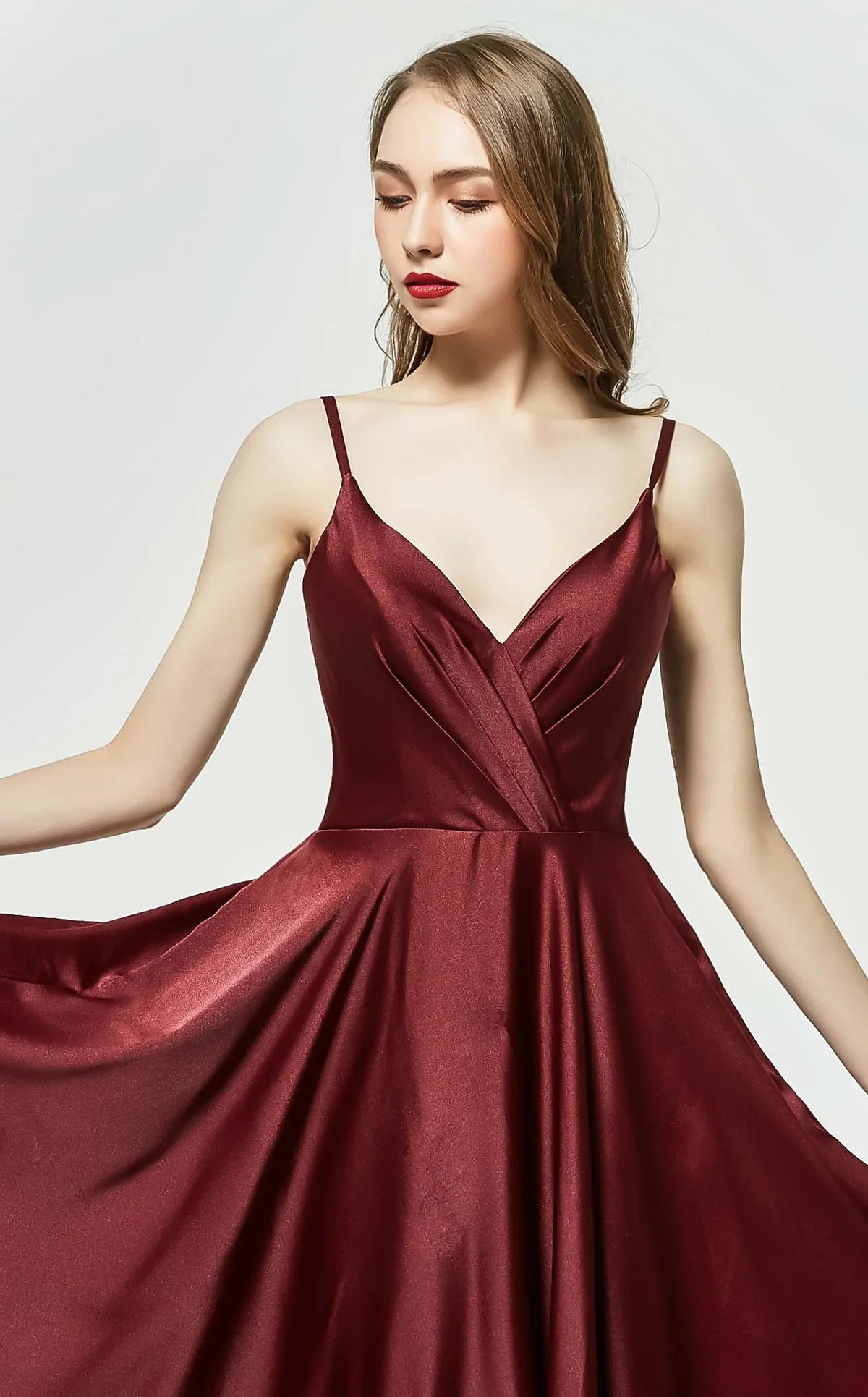 Model showcasing the elegant J19025 V-neck ball gown in rich berry hue with a flattering A-line silhouette.