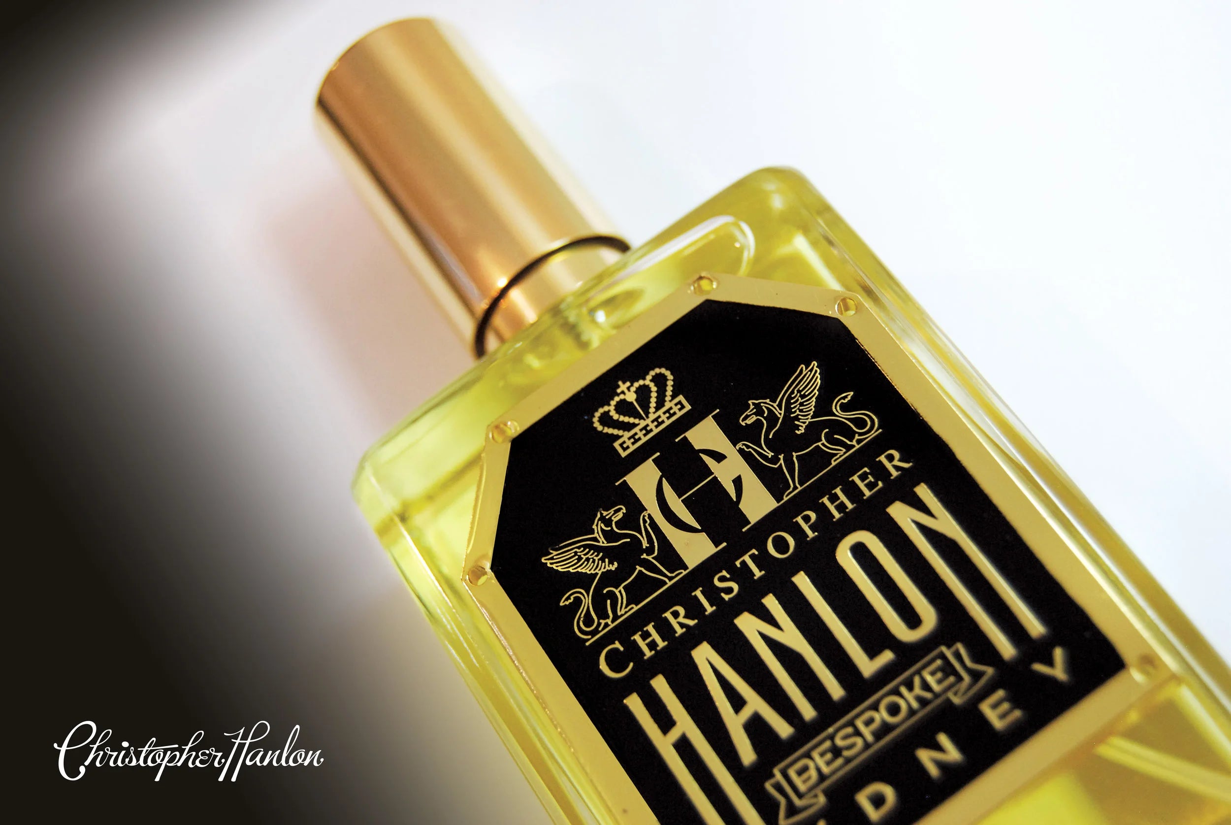 Bespoke oud perfume by CHRISTOPHER HANLON® displayed in an elegant bottle with a golden cap.