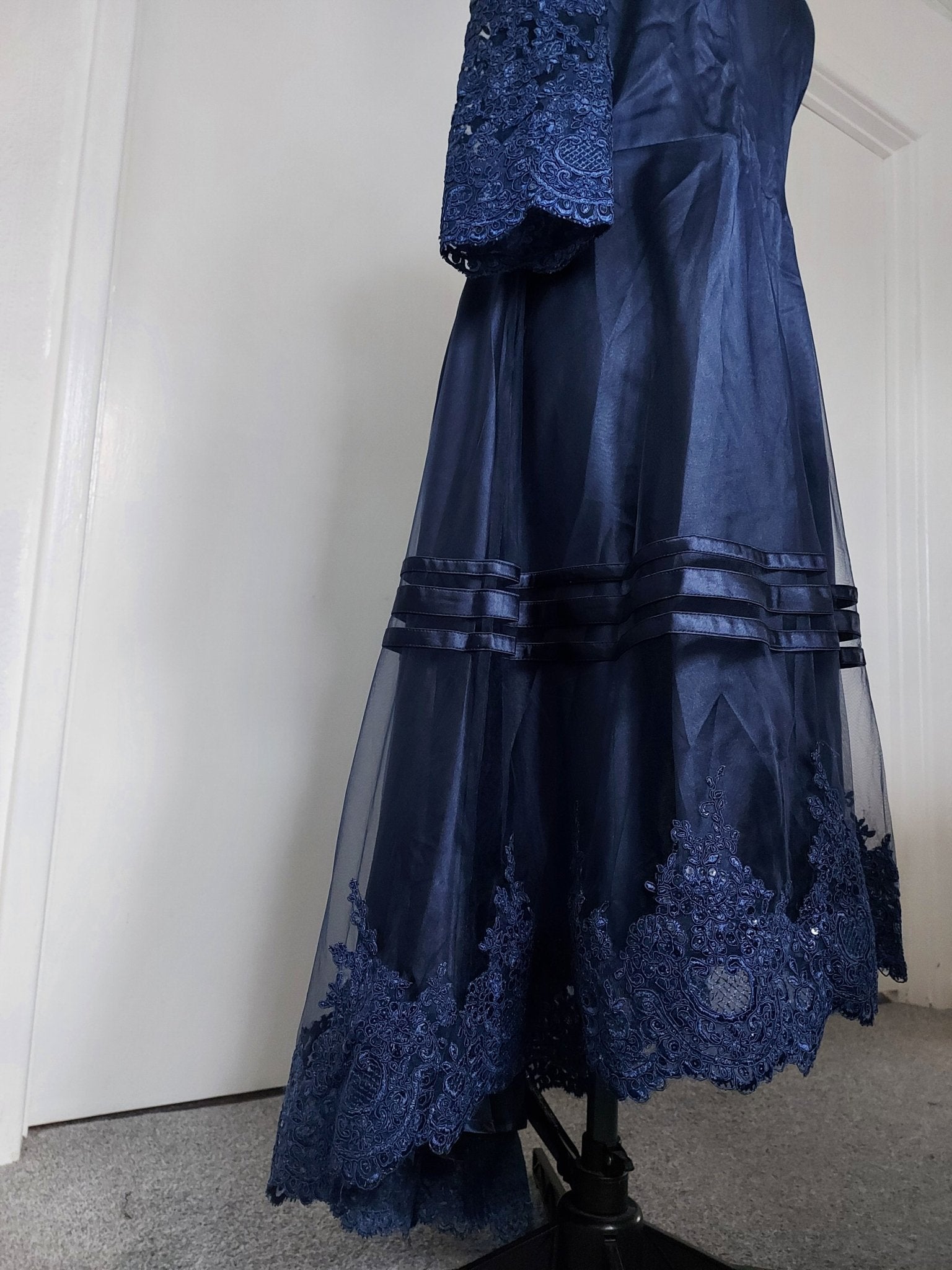 The midnight fold collar high-low mum dress showing elegant navy blue fabric and lace detailing.