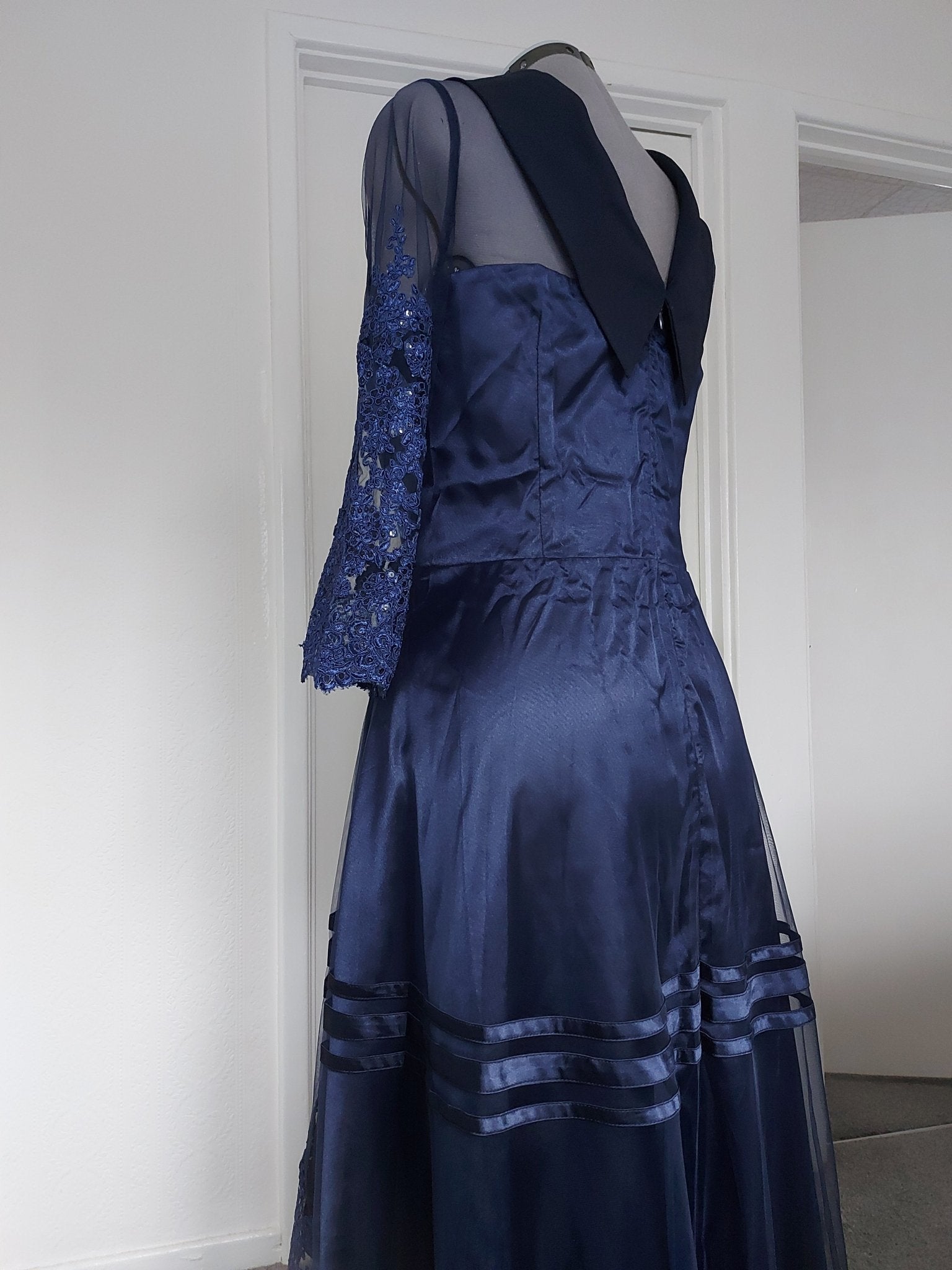 The midnight fold collar high-low mum dress showcasing elegant navy fabric and intricate lace sleeve details.