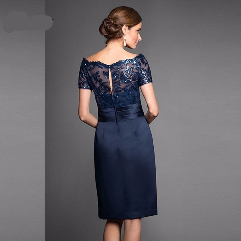 Navy blue lace appliqued knee length bridal dress showcasing cap sleeves and elegant back detail.