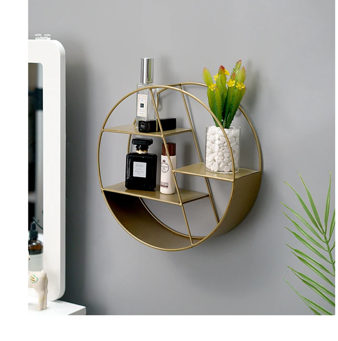 modern wall-mounted perfume display stand showcasing stylish decor with bottles and plants.