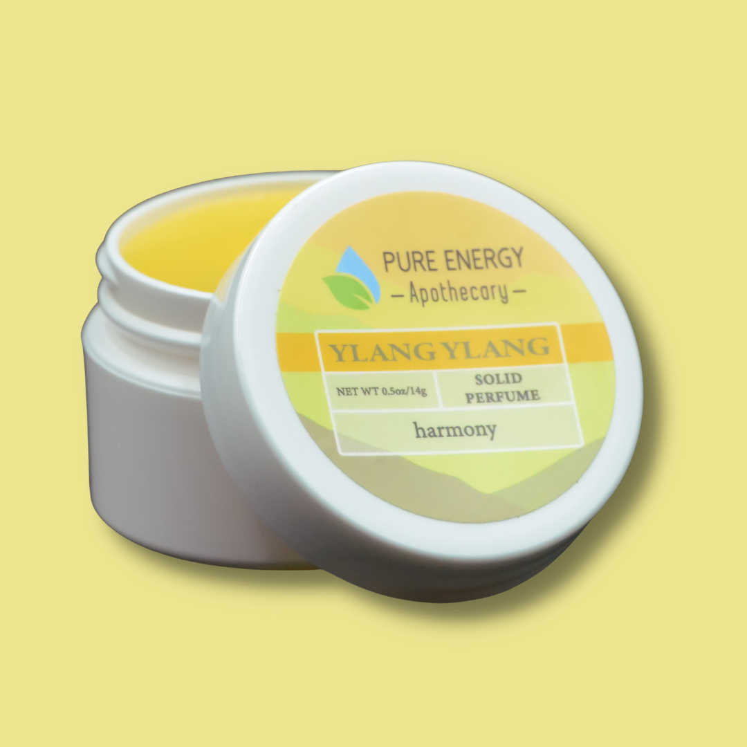Solid Perfume .50oz - Ylang Ylang in open container with vibrant label, highlighting aromatic and aromatherapy benefits.