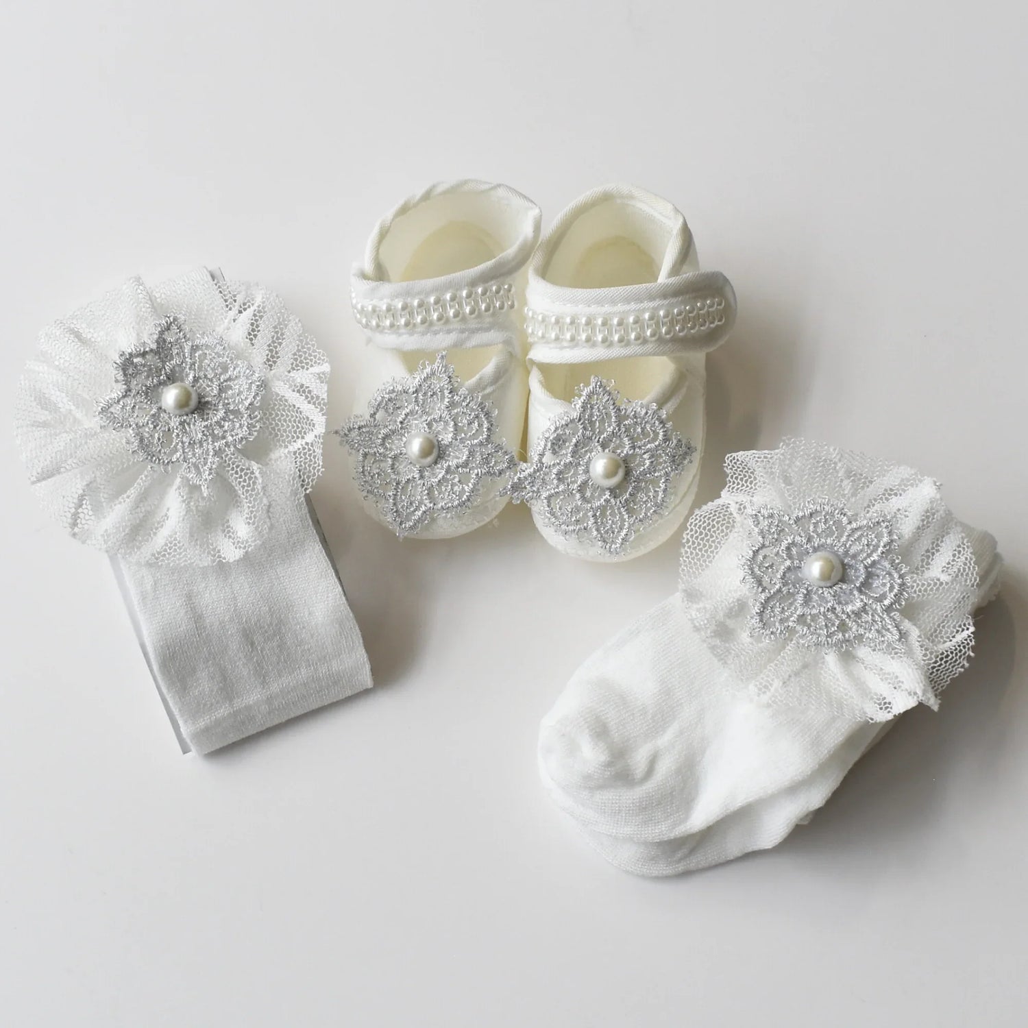 Baby Bliss Baby Shoes Set featuring elegant baby shoes, matching headband, and cozy white tights with lace details.