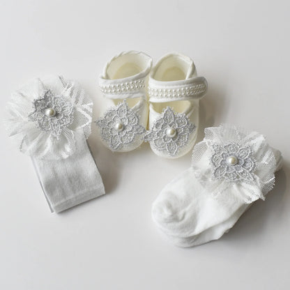 Baby Bliss Baby Shoes Set featuring elegant baby shoes, matching headband, and cozy white tights with lace details.