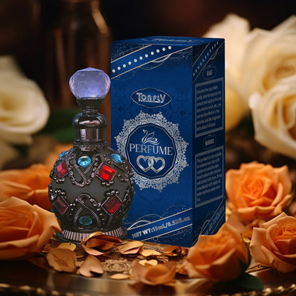 NNETM Enchanted Arabian Dreams Essential Oil Perfume bottle with ornate design and blue packaging surrounded by roses.