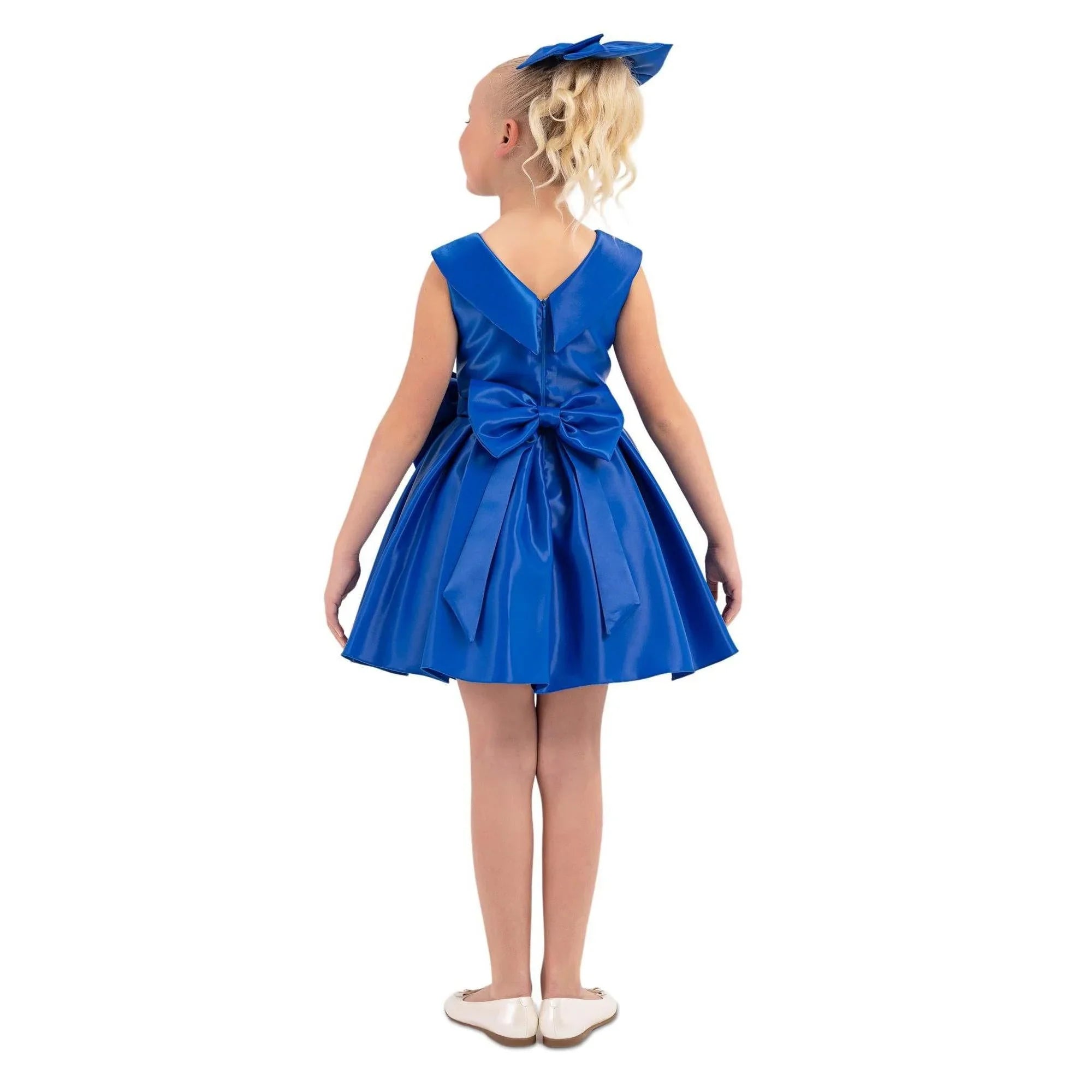 Girls formal satin dress Little girl wearing a blue Stellar Satin Girls Formal Dress with a big bow at the waist and back, showcasing its elegant design.
