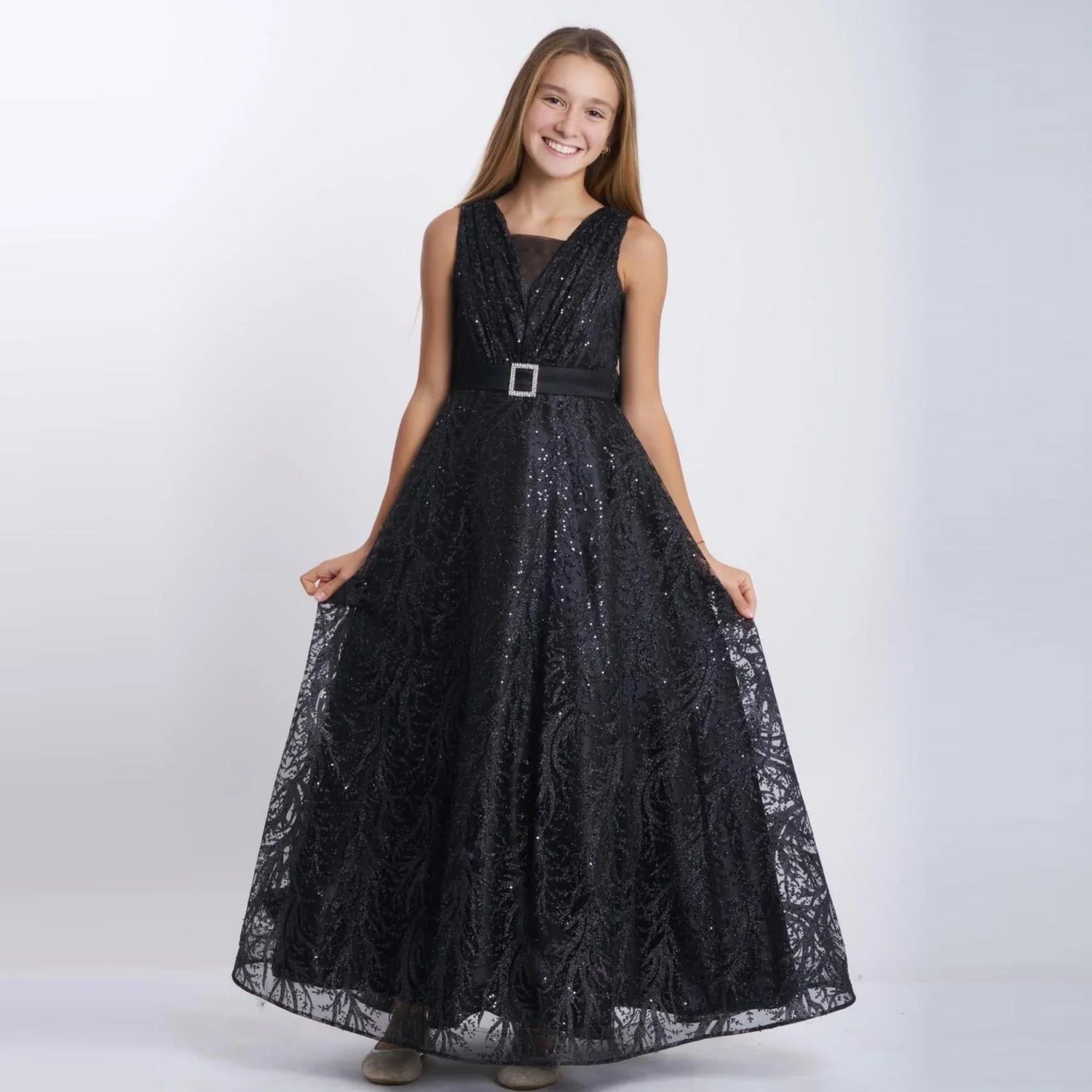 Sparkling Beauty Girls Formal Dress worn by a smiling girl in a stunning black long tulle gown with sparkles.