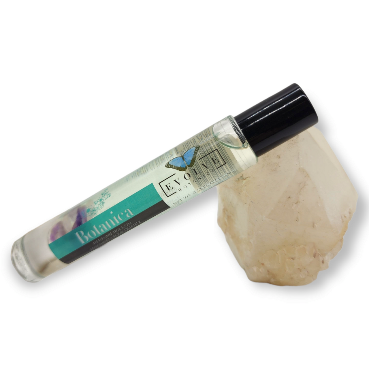 Gemstone Perfume Roll On - Botanica displayed beside a crystal, showcasing the elegant glass packaging.