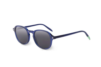 Round indigo blue sunglasses with dark lenses and mint green temple tips on white background