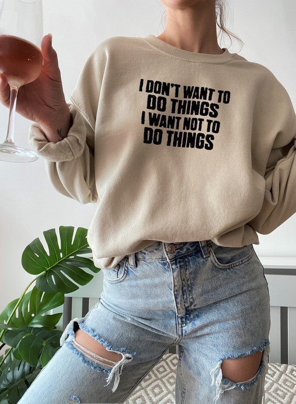 I Dont Want To Do Things Sweat Shirt showcased on model holding a drink, styled with ripped denim jeans.