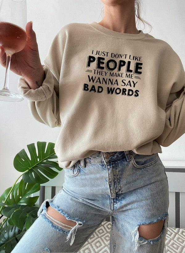 Person wearing I Just Dont Like People Sweat Shirt, holding a drink, showcasing casual fashion style.