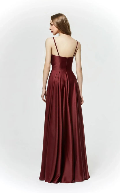 Back view of model wearing J19025, a floor-length burgundy ball gown with thin straps and elegant design.