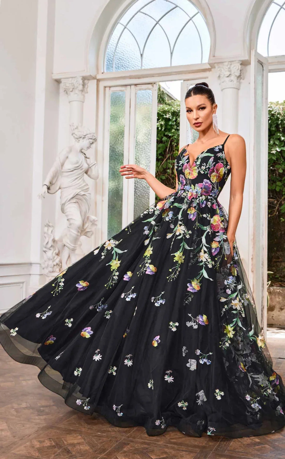 J24046 gown features a bold V-neckline with oversized floral designs on a flowing A-line skirt.
