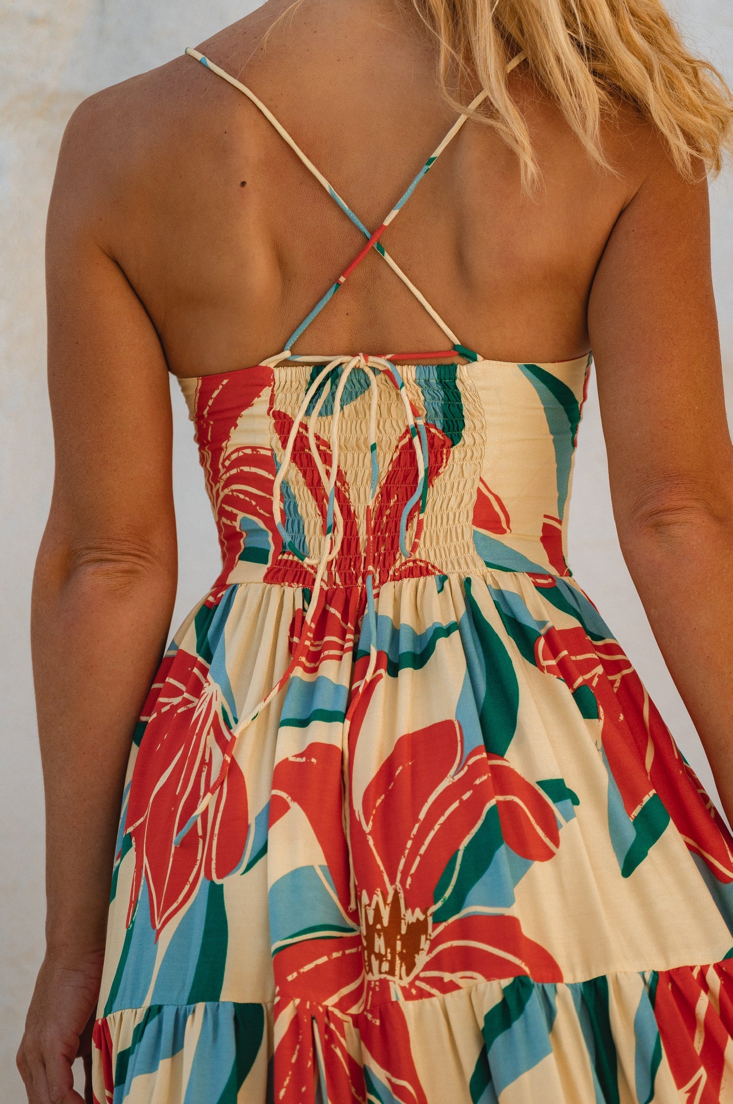 Back view of the Sea Dreamer Strappy Midi Dress showing smocked details and floral design.