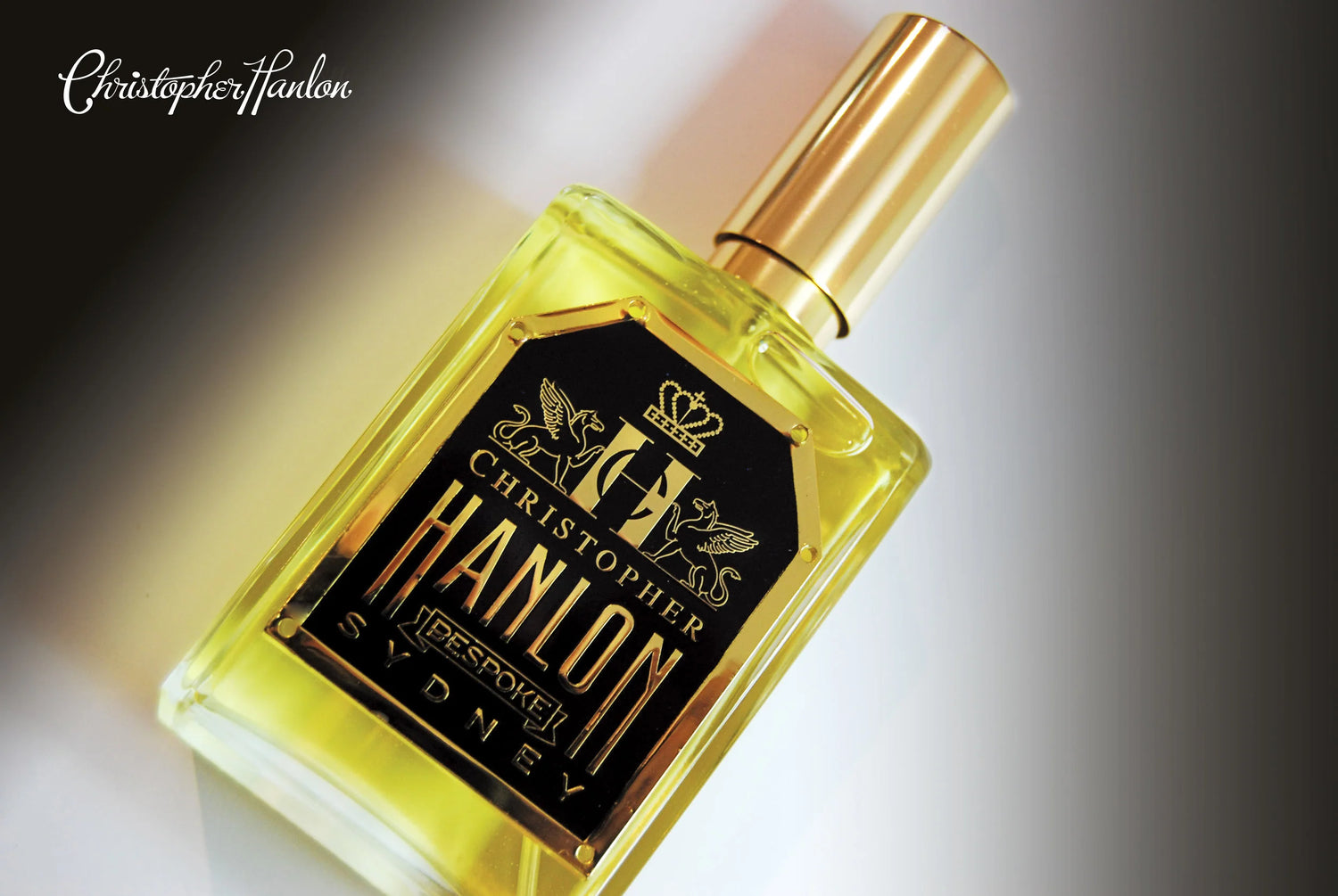 Bespoke oud perfume by CHRISTOPHER HANLON® displayed in an elegant bottle design with golden accents.