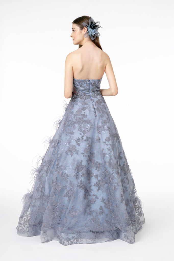 Back view of a model wearing a Feather Embellished Embroidered Sweetheart Mesh/Lace Long Dress in a soft blue hue.
