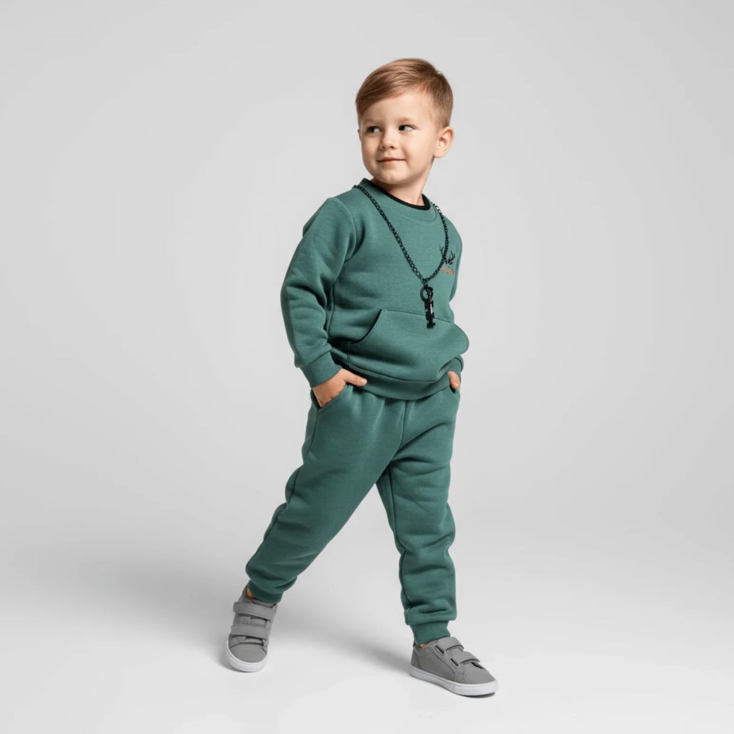 Fall King Boys Joggers Set featuring a stylish young boy in a green 2-piece jogger outfit.