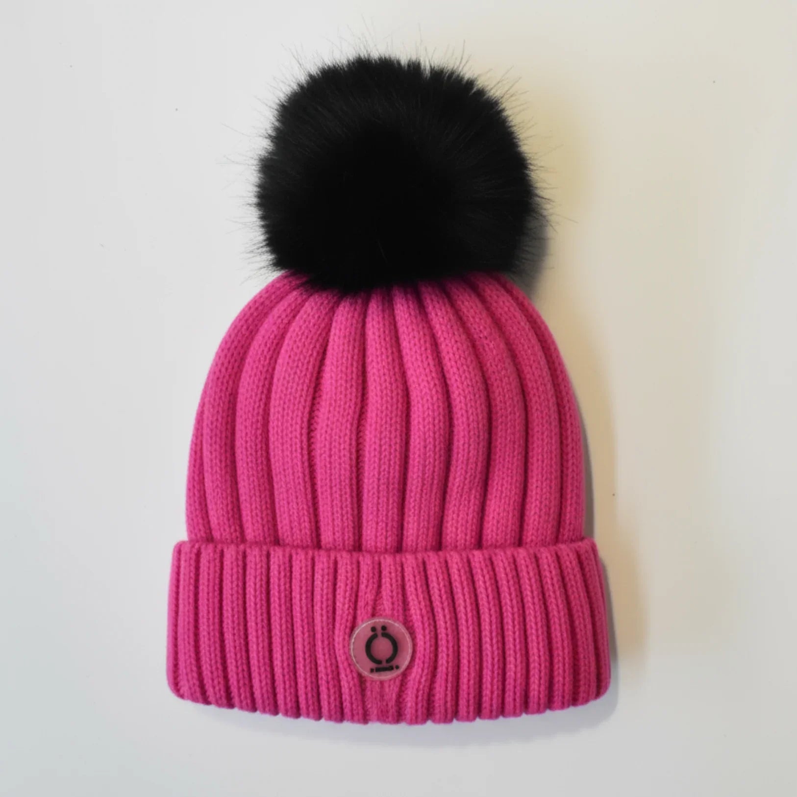 Fushia Tuque with removable black fur pompom and soft polar fleece lining, perfect for winter fashion.