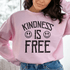 Woman wearing a pink sweatshirt with the text &