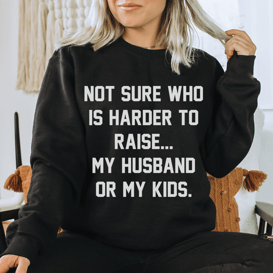 Woman wearing a cozy black sweatshirt that says &