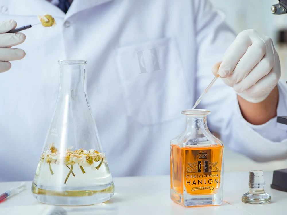 Scientist preparing fragrances for the free perfume collection by CHRISTOPHER HANLON® in a laboratory.