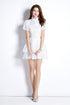 White Embroidered Puff Sleeve French Dress worn by model, featuring intricate texture and playful puff sleeves.